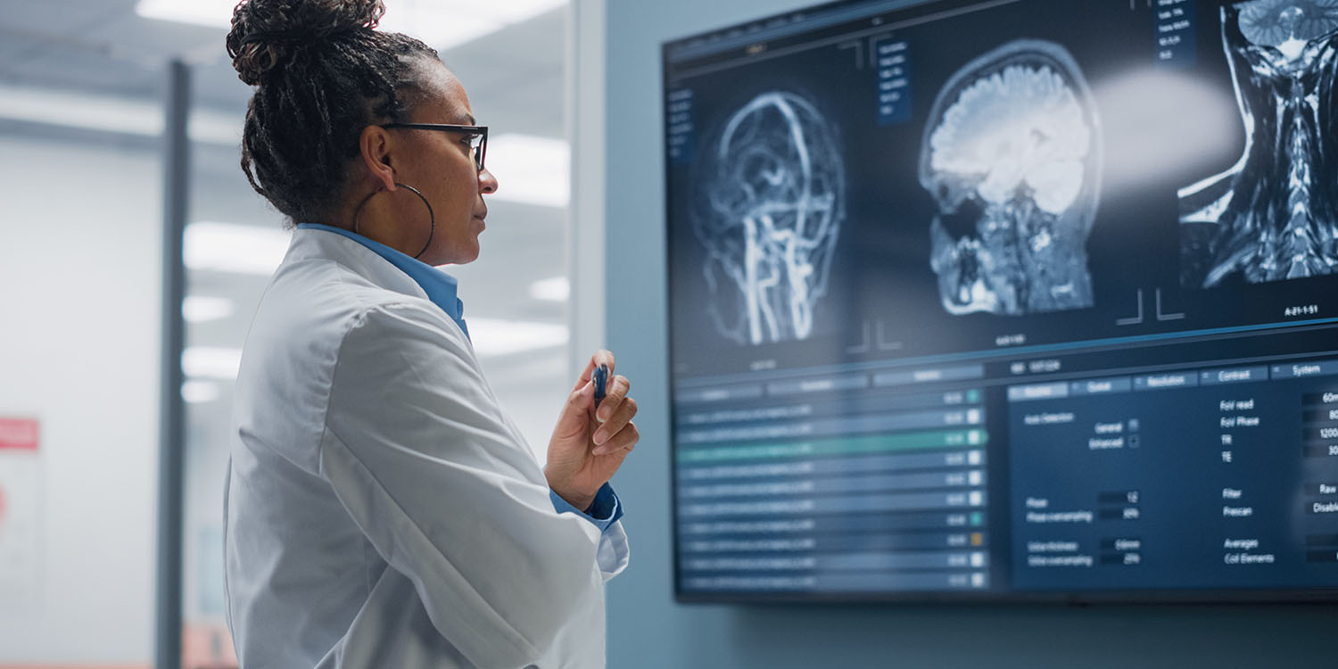 A dosimetry team member looks at MRI of brain