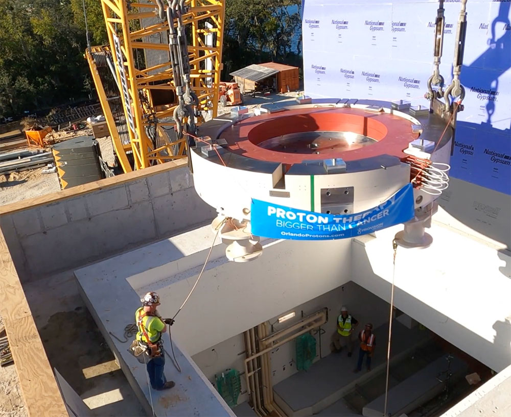 A crane lifts the cyclotron into Provision CARES Proton Therapy Orlando